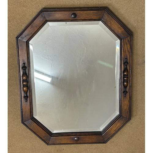 1096 - Two vintage oak wall mirrors with bevelled glass. Largest 70 x 46cm and smallest 54 x 44cm.