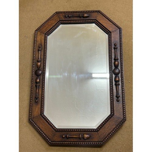 1096 - Two vintage oak wall mirrors with bevelled glass. Largest 70 x 46cm and smallest 54 x 44cm.