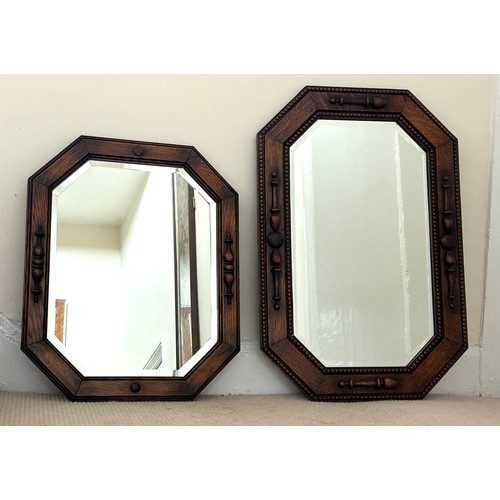 1096 - Two vintage oak wall mirrors with bevelled glass. Largest 70 x 46cm and smallest 54 x 44cm.