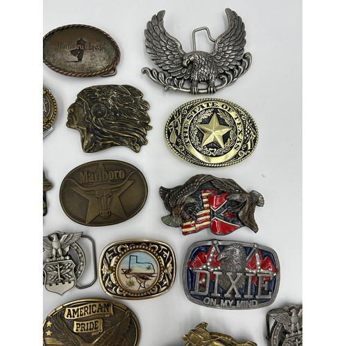 422 - Collection of 34 belt buckles, mainly in brass with Native American designs, eagles, motorbikes etc.