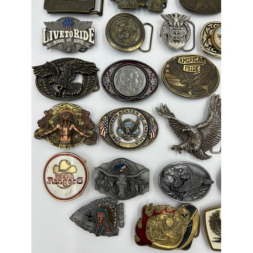 422 - Collection of 34 belt buckles, mainly in brass with Native American designs, eagles, motorbikes etc.