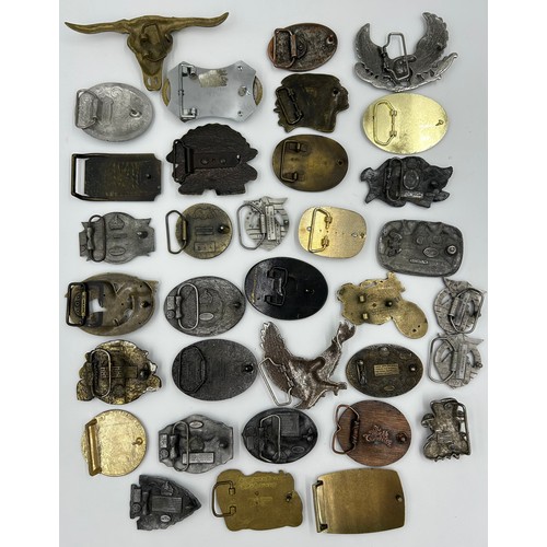 422 - Collection of 34 belt buckles, mainly in brass with Native American designs, eagles, motorbikes etc.