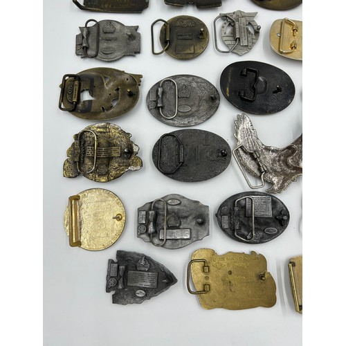 422 - Collection of 34 belt buckles, mainly in brass with Native American designs, eagles, motorbikes etc.