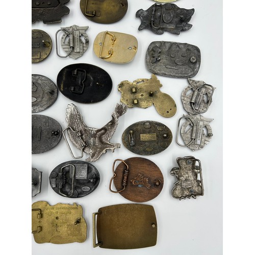 422 - Collection of 34 belt buckles, mainly in brass with Native American designs, eagles, motorbikes etc.