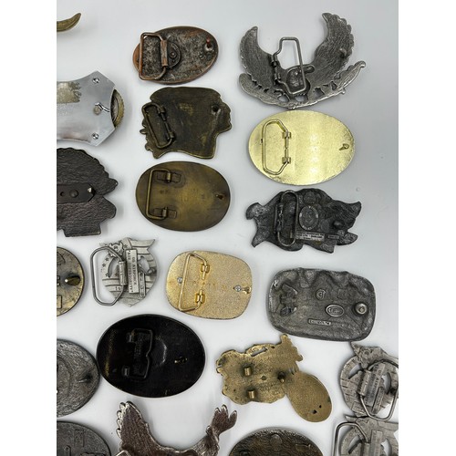 422 - Collection of 34 belt buckles, mainly in brass with Native American designs, eagles, motorbikes etc.