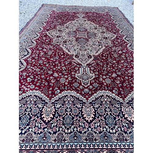 1102 - A good quality red ground wool carpet 315cm x 223cm.