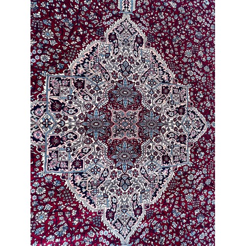 1102 - A good quality red ground wool carpet 315cm x 223cm.