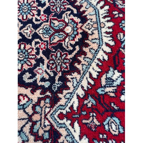 1102 - A good quality red ground wool carpet 315cm x 223cm.