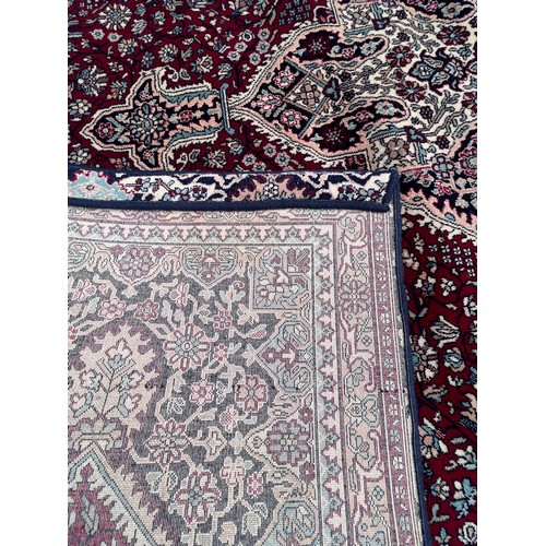 1102 - A good quality red ground wool carpet 315cm x 223cm.