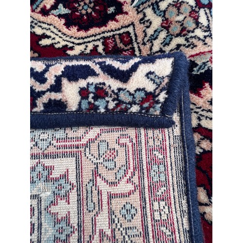 1102 - A good quality red ground wool carpet 315cm x 223cm.