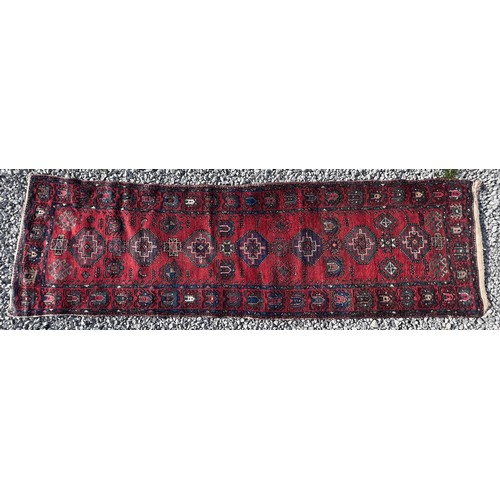 1103 - A red ground wool carpet runner 273 x  80cm.