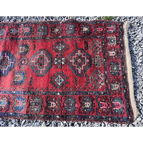 1103 - A red ground wool carpet runner 273 x  80cm.