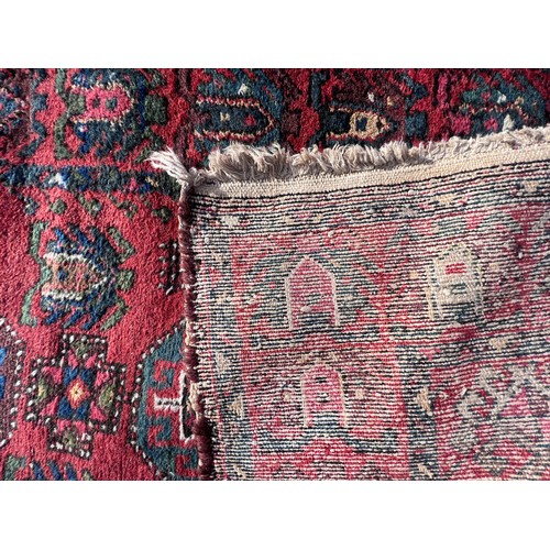 1103 - A red ground wool carpet runner 273 x  80cm.