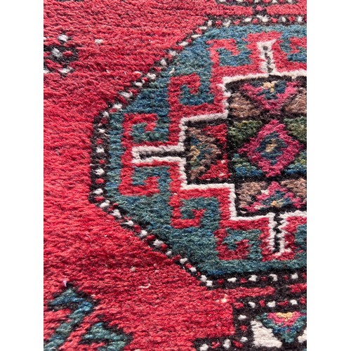 1103 - A red ground wool carpet runner 273 x  80cm.