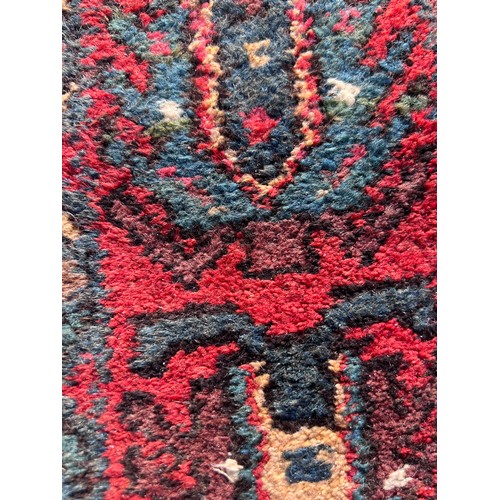 1103 - A red ground wool carpet runner 273 x  80cm.