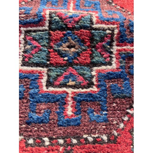 1103 - A red ground wool carpet runner 273 x  80cm.