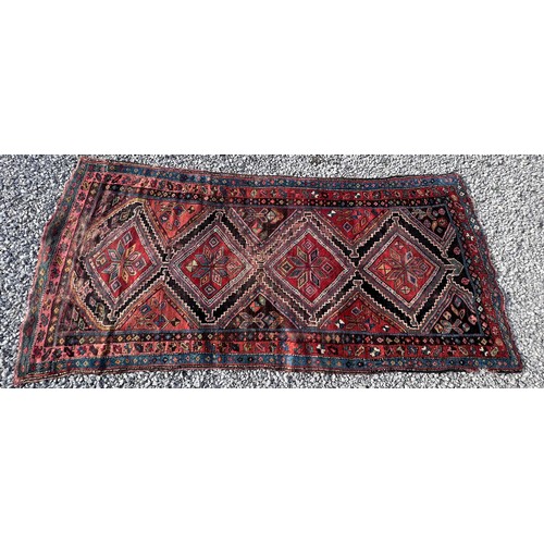 1104 - An orange and blue ground wool rug. 278cm x 131cm.