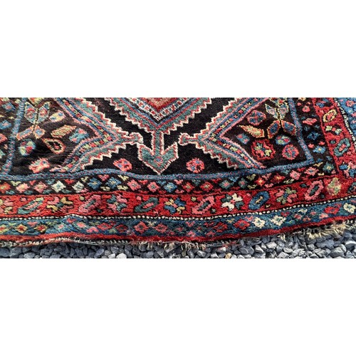 1104 - An orange and blue ground wool rug. 278cm x 131cm.