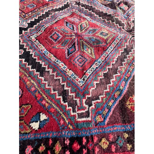 1104 - An orange and blue ground wool rug. 278cm x 131cm.