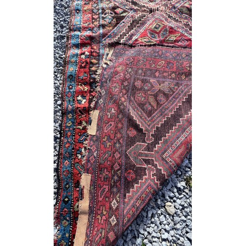 1104 - An orange and blue ground wool rug. 278cm x 131cm.