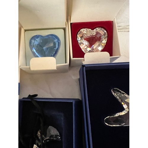 285 - A collection of boxed Swarovski crystal ornaments to include flowers, hearts, shells etc.