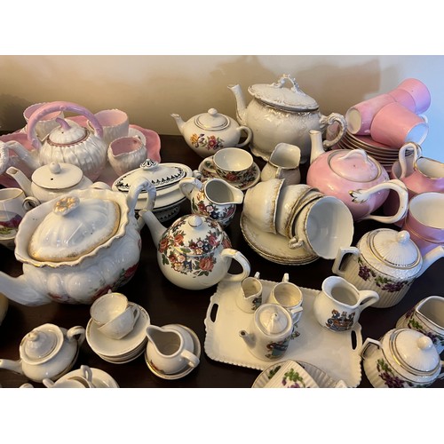 192 - A quantity of late 19thC and early 20thC children’s and doll’s tea services, ribbon plates etc.