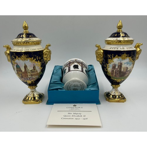 197 - Coalport: Two twin-handled commemorative urn shaped vases with covers and twin goat head handles, on... 