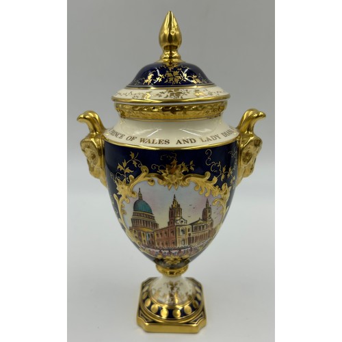 197 - Coalport: Two twin-handled commemorative urn shaped vases with covers and twin goat head handles, on... 