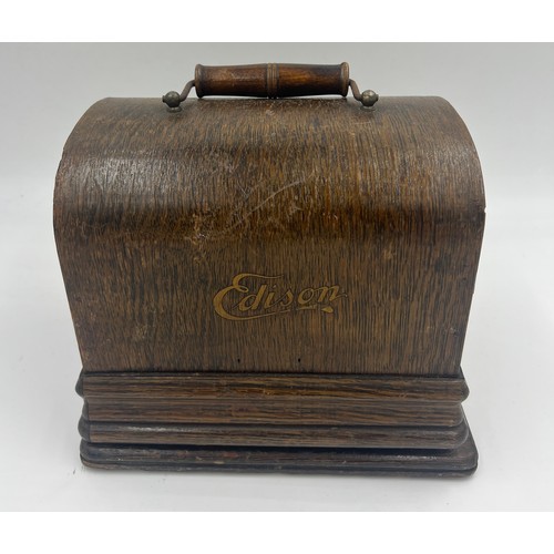 1302 - A child’s metal sewing machine in an oak Edison case. 25cm w x 22cm h.