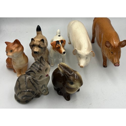 163 - A collection of ceramic animals to include Beswick Jack Russell dog, Wallqueen pig, cat, Doulton pig... 