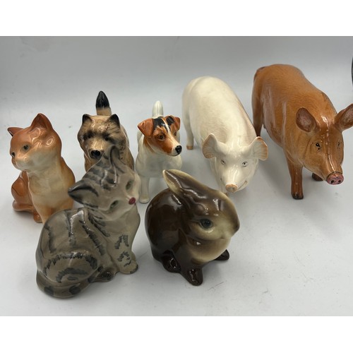 163 - A collection of ceramic animals to include Beswick Jack Russell dog, Wallqueen pig, cat, Doulton pig... 