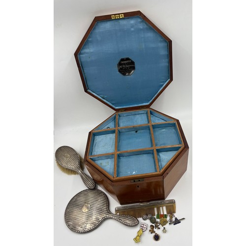 1310 - A miscellany to include an octagonal inlaid box, silver backed  mirror, brush, comb and various badg... 