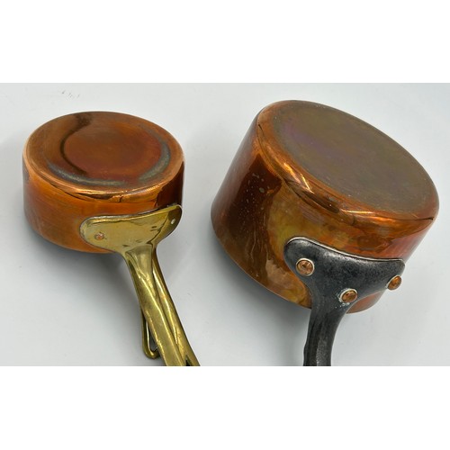 415 - Set of 7 French copper pans, the larger two with cast iron handles, the smaller ones with brass hand... 