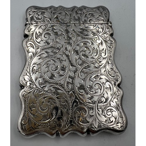 912 - A silver card case with foliage scroll engraving and initials to front. 9cm x 6.5cm. Birmingham 1902... 