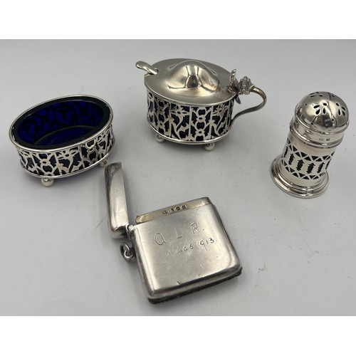 913 - A three piece silver cruet with blue glass liners Birmingham 1900/1919, a plated mustard spoon and a... 