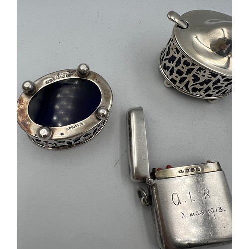 913 - A three piece silver cruet with blue glass liners Birmingham 1900/1919, a plated mustard spoon and a... 