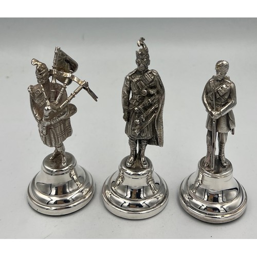 914 - Hallmarked silver figures, two Scottish Highlanders and one Gurkha. Tallest 10cm h. London 1938, 196... 