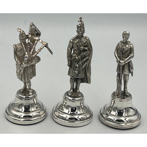 914 - Hallmarked silver figures, two Scottish Highlanders and one Gurkha. Tallest 10cm h. London 1938, 196... 