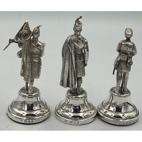 914 - Hallmarked silver figures, two Scottish Highlanders and one Gurkha. Tallest 10cm h. London 1938, 196... 