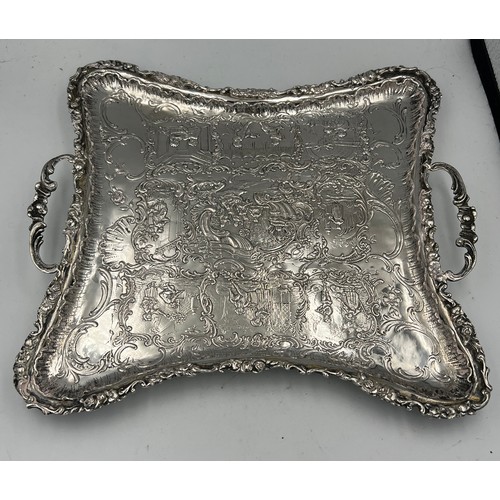 915 - A continental .800 white metal twin handled tray raised on four feet. Weight 350gm.