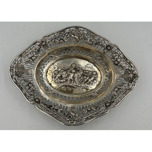 916 - An unmarked continental white metal pierced and embossed oval dish. 13cm x 17cm. Weight 89.2gm.