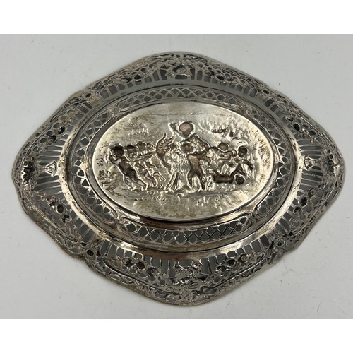 916 - An unmarked continental white metal pierced and embossed oval dish. 13cm x 17cm. Weight 89.2gm.