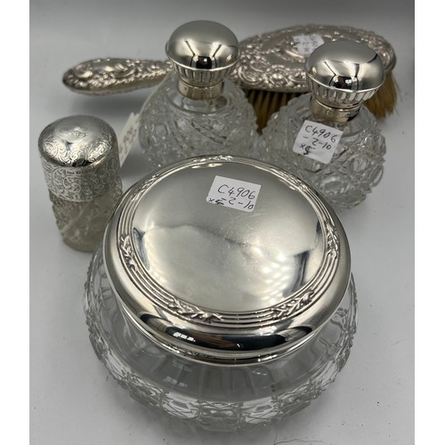 917 - Four silver topped glass dressing table jars. Sheffield 2000, maker Carr’s of Sheffield Ltd and a Ch... 