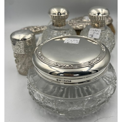 917 - Four silver topped glass dressing table jars. Sheffield 2000, maker Carr’s of Sheffield Ltd and a Ch... 