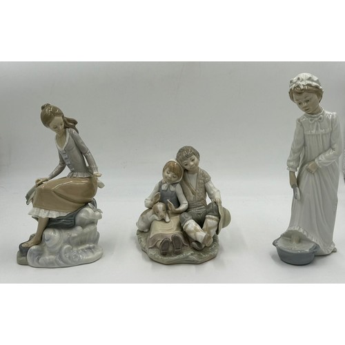 151 - Three Lladro figurines to include 'At the seaside', 'Washing up girl' 23cm h, and 'Friendship.