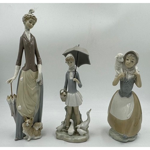 150 - Three Lladro figurines to include Girl with umbrella and geese 4510; Lady with umbrella and dog 4761... 