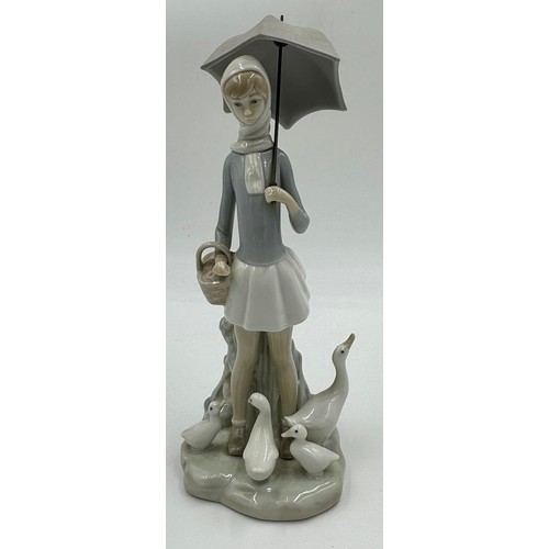 150 - Three Lladro figurines to include Girl with umbrella and geese 4510; Lady with umbrella and dog 4761... 