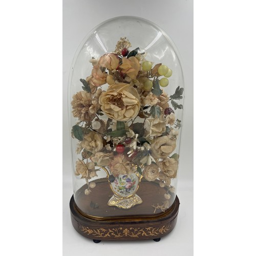 1313 - A glass display dome containing a vintage floral display in continental ceramic vase on an inlaid ro... 