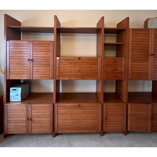 29 - A mid 20thC modular teak bookcase with seven cupboards and three small drawers. 299cm w x 211cm h x ... 