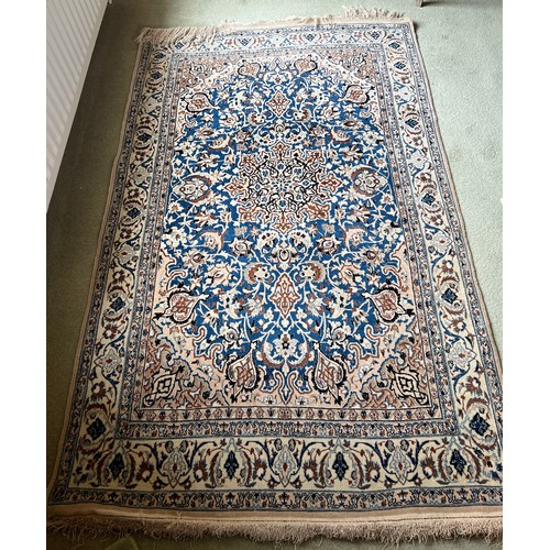 1099 - Hand knotted silk Persian rug. 190cm l x 119cm w.